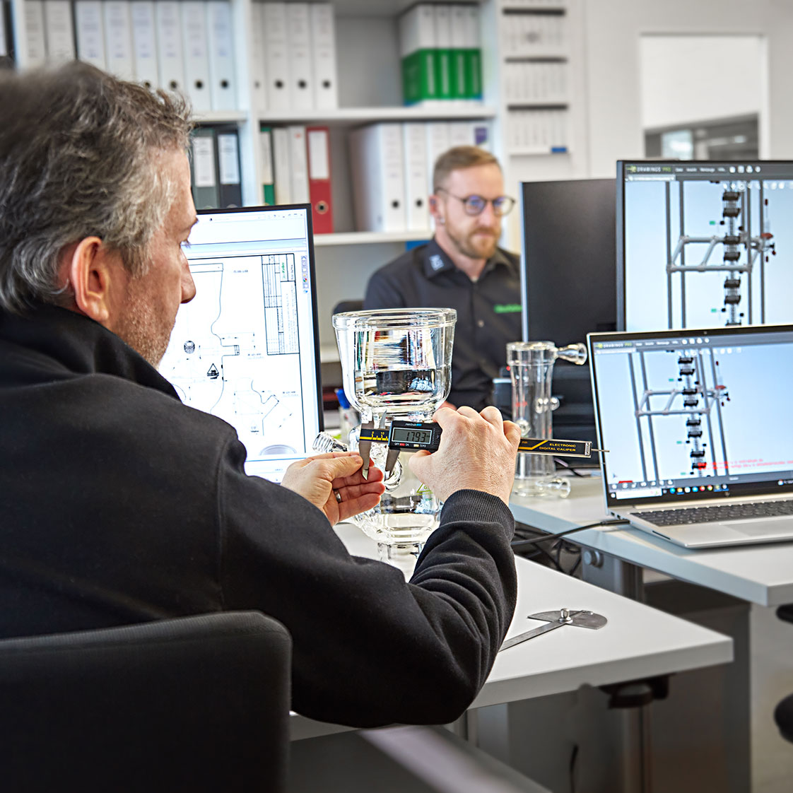 GlasKeller staff comparing CAD against glassware